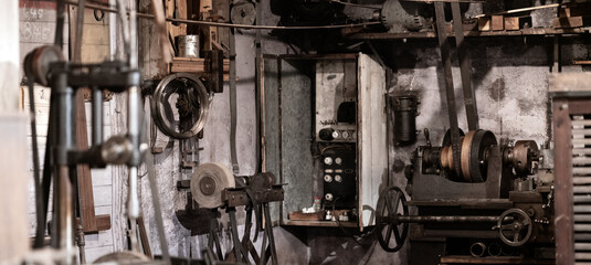 Vintage tools, equipment and antique objects in authentic historical carpentry shop. Woodwork, blacksmith and restoration concept.