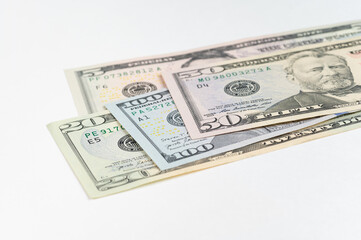 5, 20, 50, 100 dollars banknotes at different angles. Close up of dollars on white background.