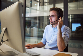 Telemarketing, man and employee in call center with headphones at desk. Worker or consultant at...