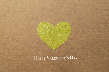 Golden paper heart in the center of craft background. High quality photo card with text
