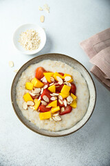 Homemade oatmeal porridge with strawberry and mango
