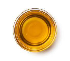 Honey in a glass container on a white background.