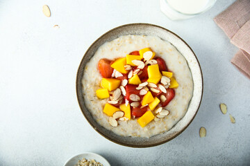 Homemade oatmeal porridge with strawberry and mango