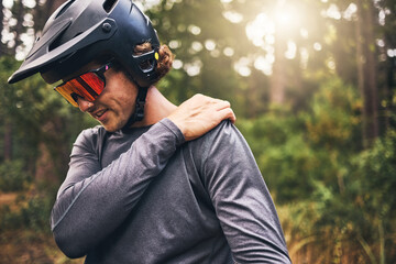 Bike cyclist, fitness and injury in nature forest, environment or Australian woods after exercise, training and workout. Shoulder pain, medical emergency and healthcare for sports man after accident
