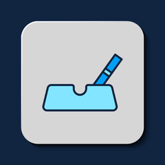 Filled outline Ashtray with cigarette icon isolated on blue background. Vector
