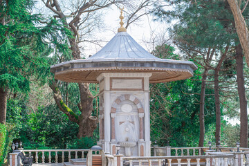 A historical fountain in the park. Domed old fountain.
