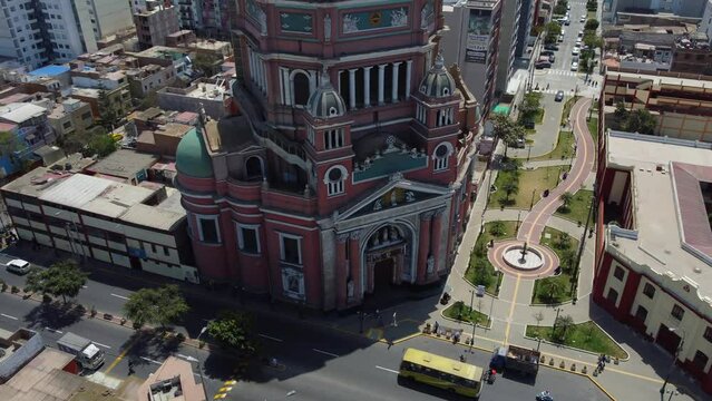 Drone 4k video of the tallest church in the city of Lima in Peru. Its called "Iglesia del Inmaculado Coraz&oacute;n de Mar&iacute;a" Drone hovers and tilts up to the church's dome with a statue of the virgin Mary.