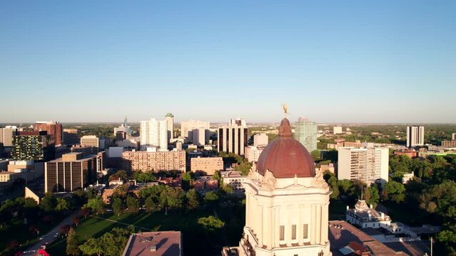 Smooth drone shot of downtown Winnipeg Skyline with the Golden Boy.