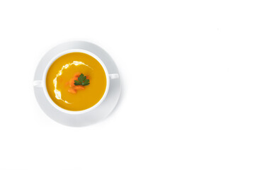 Carrot soup with cream and parsley isolated on white background. Top view. Copy space