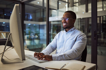 Computer, african businessman and working at night typing on keyboard for corporate research in office. Professional, happy and black man planning a management review for employee with technology
