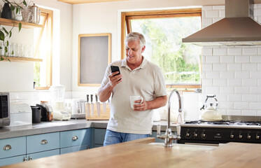 Senior man, morning coffee and phone looking happy while reading text message, online news or...