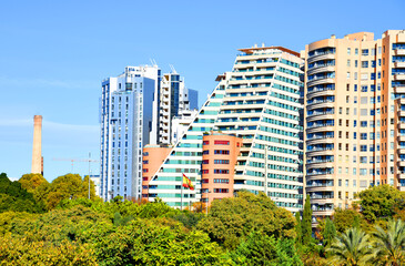 Facade house buildings at Central Park on Turia River. Residential building and apartments. Spain modern architecture. Green trees on Buildings architecture background. House with window and balcony.