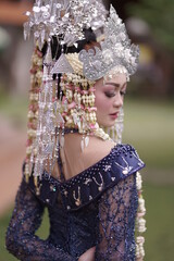 The model who is wearing suntiang traditional clothes from the city of padang, indonesia, looks very elegant and beautiful