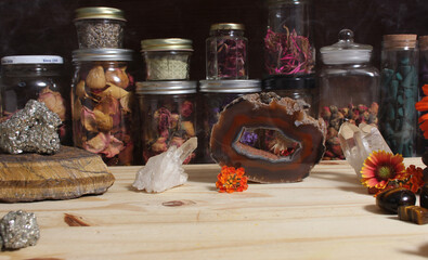 Meditation Altar With Rock Crystals and Flowers. Jars of Herbs in Background