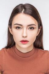 Fototapeta premium Portrait of a young beautiful brunette model, isolated on white background