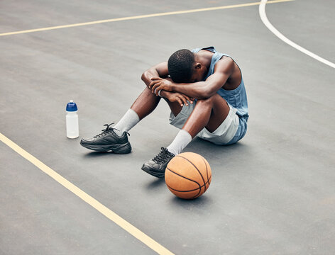 Basketball man, sports burnout and game fatigue on court sport training, muscle injury from exercise on ground and sad with mistake. Sick, depressed and african american athlete with competition pain