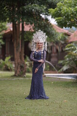 The model who is wearing suntiang traditional clothes from the city of padang, indonesia, looks very elegant and beautiful