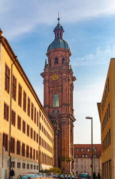 The highest church tower in Würzburg, seen from the street Schönthalstraße. The tower with a ribbed dome and crowned by a star-shaped lantern belongs to the Neubaukirche, a former university church.