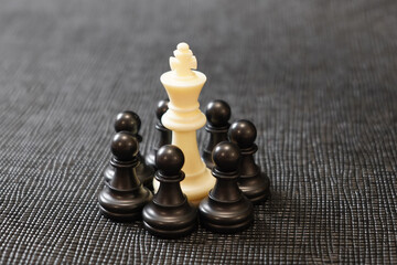 white king surrounded by black pawns