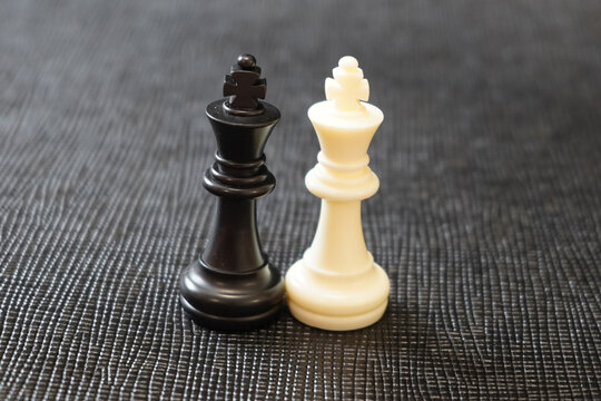 black and white chess king stands over black background