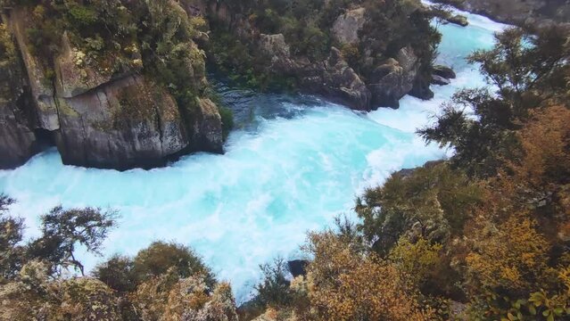 river rapids at huka falls near taupo or rotorua north island new zealand, landscape with water, rocks and trees. High quality photo