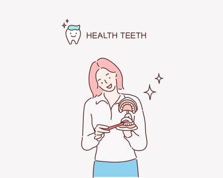 
Dentist showing on a jaw model how to clean the teeth with tooth brush properly and right. Hand drawn style vector design illustrations.