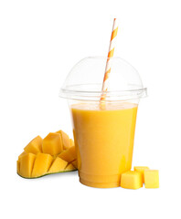 Plastic cup of tasty mango smoothie and fresh fruit on white background