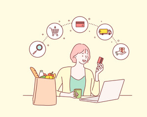 Woman holding credit card while using laptop near paper bag with groceries. online shopping concept. Hand drawn style vector design illustrations.
