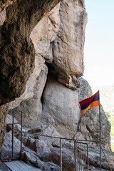 Naklejka premium Armenian flag on the background of the rock.