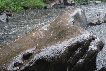 Rain on the river Gorsky Tikich rocky banks near high granite rocks. Buksky canyon, Cherkasy region