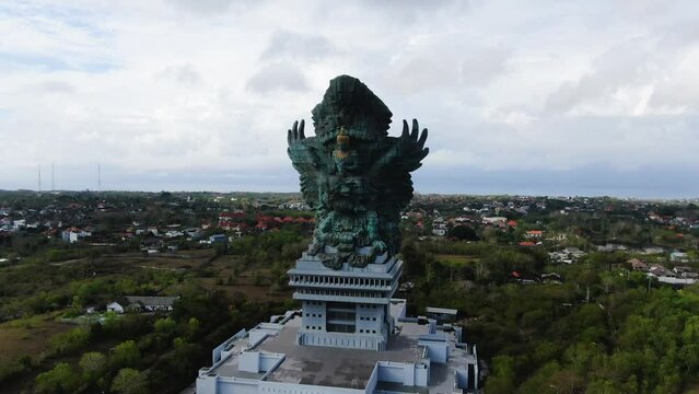 Iconic Garuda Wisnu Kencana statue in Bali, aerial drone orbit view