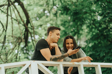 Boy showing something on the phone to the girl