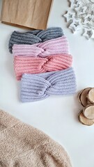 Fashionable knitted headbands autumn-winter. The headbands lies on a white background. Product layout. Knitting. Hobby.