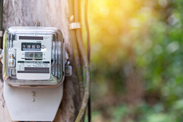 Kilowatt hour meter on blur sky background. Electric power meter measuring power usage. Electricity...