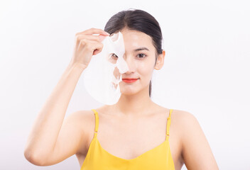 A young woman wearing a facial mask against a white background