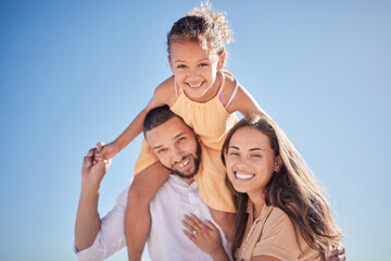 Fototapeta na wymiar Happy, love and freedom with family against the blue sky together for relax, support and care. Smile, summer and girl on father shoulders with mother in the outdoor for lifestyle, youth and nature