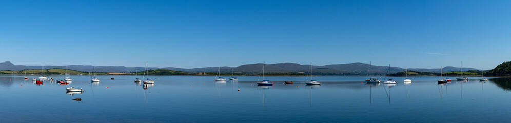 Fototapeta na wymiar panorama view of Bantry Bay in County Cork with many colorful sailboats anchored in the calm waters