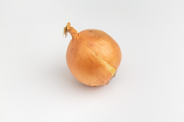 close up of raw onion with the skin isolated on white background