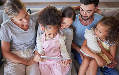 Grandparents, parents and children elearning with a tablet on sofa in family home. Kids on digital...