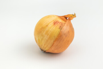 close up of raw onion with the skin isolated on white background