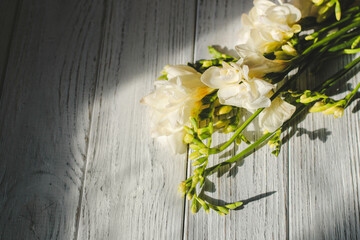 Background with a bouquet of flowers on white wooden boards.
