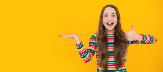 Impressed teenage girl showing recommendation copyspace. Child face, horizontal poster, teenager girl isolated portrait, banner with copy space.