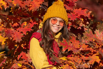 Child girl on autumn fall background, autumn kids face. happy child in sunglasses at autumn leaves on natural background