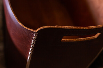 Closeup of dark brown leather bag with hole handlers