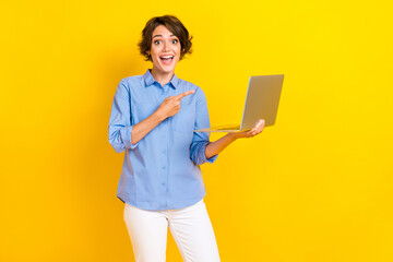 Portrait of impressed ecstatic girl with bob hairstyle wear blue blouse directing at laptop open...