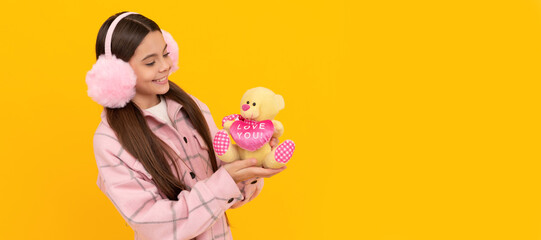 I love you so much. Happy child smile holding teddy bear. Banner of child girl with toy, studio portrait, header with copy space.