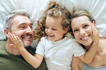 Family, happy and smile of people from above in bed at home relax in a bedroom. Mother, girl and...