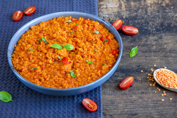 Red lentil dish with tomatoes and peppers. Vegetarian cooking