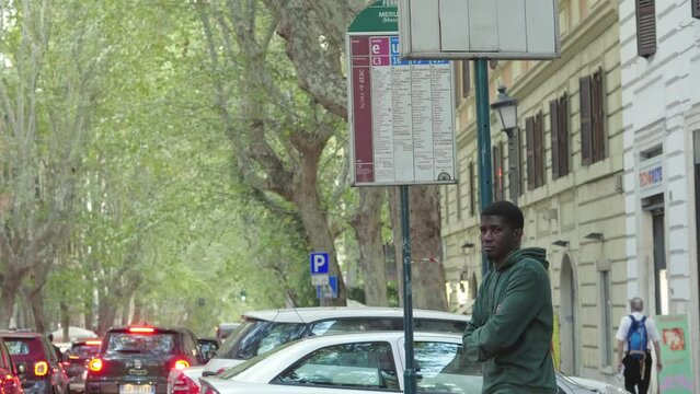 Young Handsome African American Man Waiting At The Bus Stop