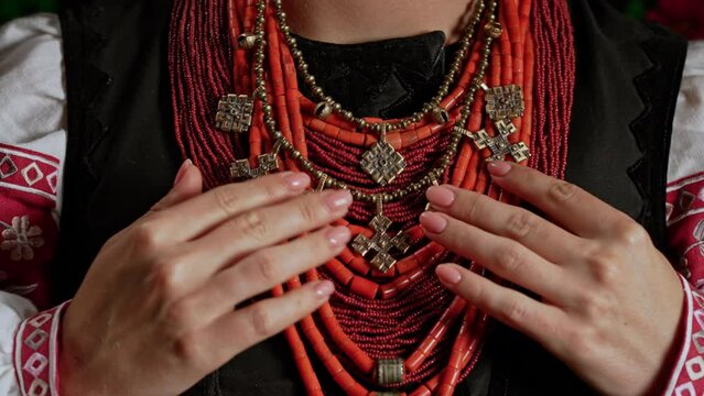 Demonstrating traditional antique jewelry necklace. National costume of Ukraine. Ukrainian woman in legacy ancient coral beads, Zgarda - archaic hutsul neck ornament of status religious purpose